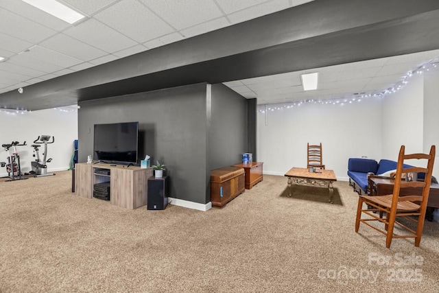 interior space featuring carpet floors, baseboards, and a drop ceiling