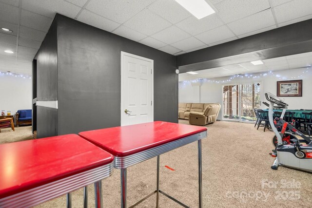 game room featuring carpet floors and a paneled ceiling