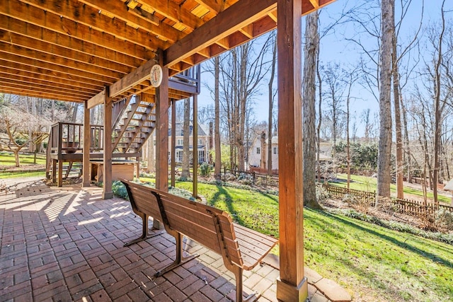 view of patio with stairway and fence