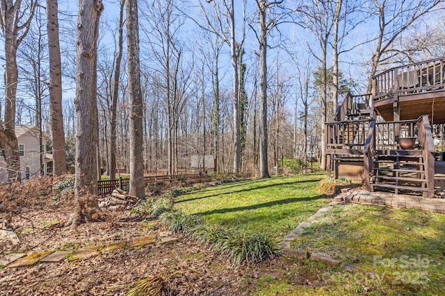 view of yard with stairway, a wooden deck, and fence