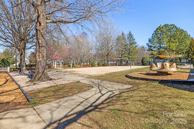 view of community with volleyball court and a yard