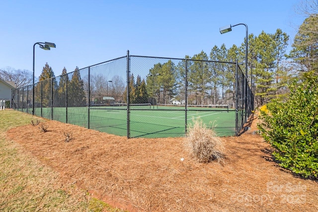 view of sport court featuring fence