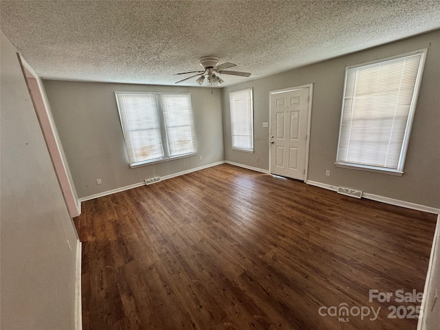 entrance foyer with visible vents, baseboards, ceiling fan, and dark wood-style flooring