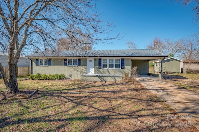 ranch-style house featuring brick siding, concrete driveway, crawl space, fence, and a carport