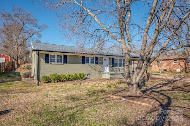 ranch-style home featuring brick siding, metal roof, crawl space, fence, and a front yard