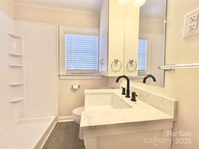 bathroom with ornamental molding, wood finished floors, vanity, and toilet