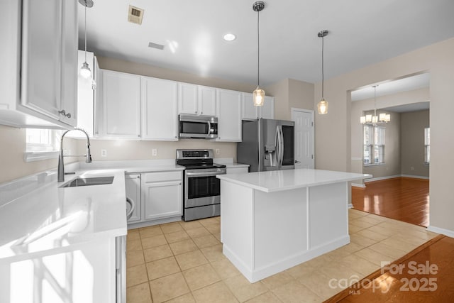 kitchen with light tile patterned floors, visible vents, stainless steel appliances, and a sink