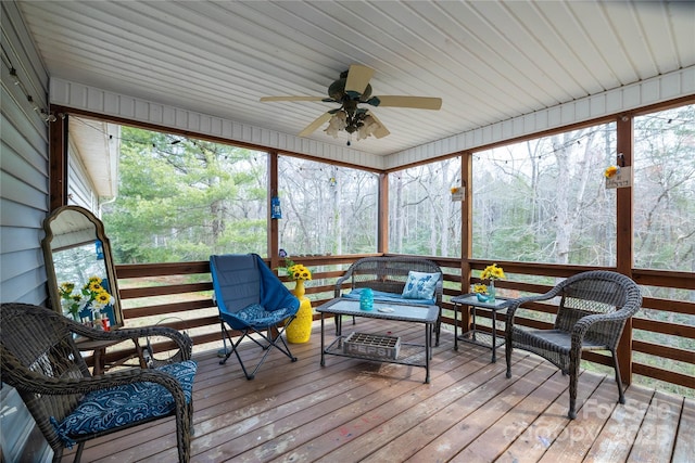 sunroom / solarium with a ceiling fan