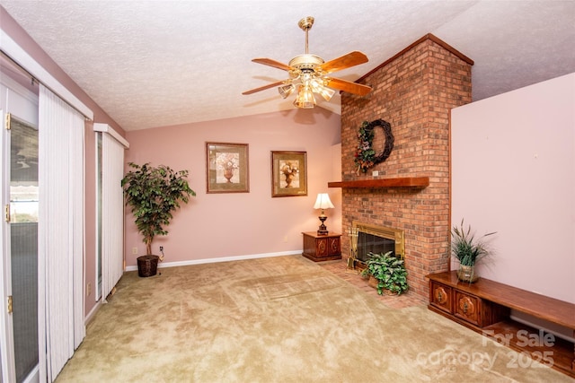 living area featuring a brick fireplace, baseboards, lofted ceiling, carpet flooring, and a textured ceiling