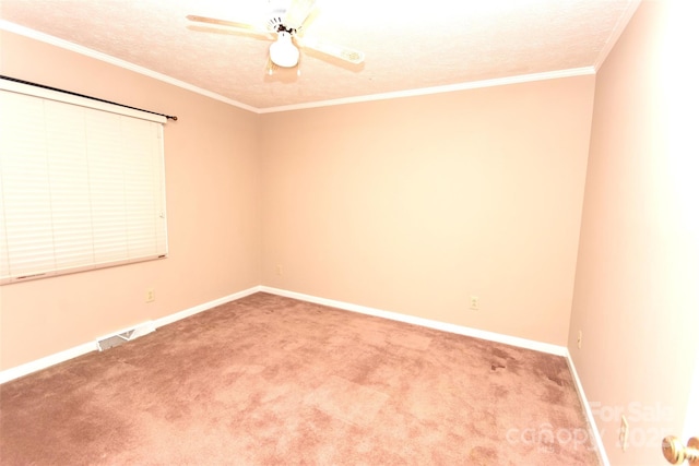 unfurnished room with visible vents, crown molding, baseboards, carpet floors, and a textured ceiling