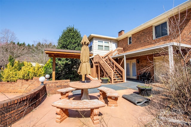 view of patio featuring stairs and outdoor dining space