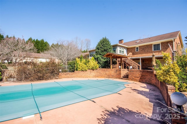 view of pool featuring a patio area, a fenced in pool, and stairs