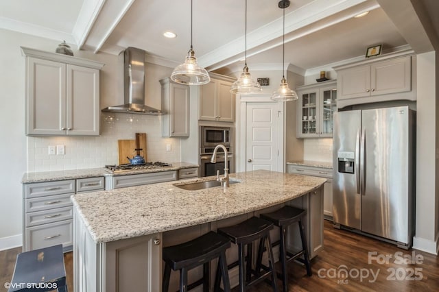 kitchen featuring stainless steel appliances, glass insert cabinets, an island with sink, and wall chimney exhaust hood