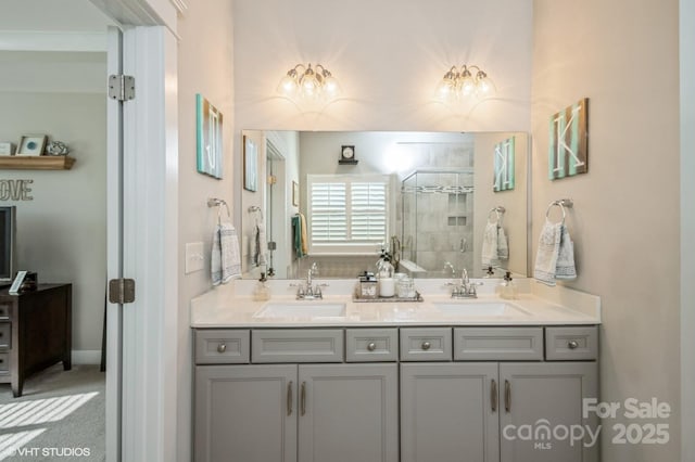 full bathroom with double vanity, a stall shower, and a sink