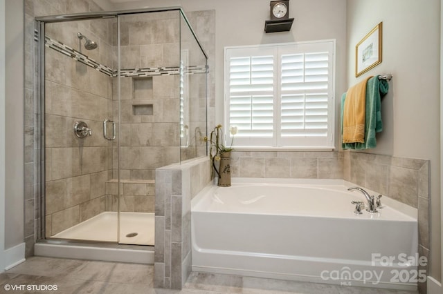 bathroom with a stall shower and a garden tub