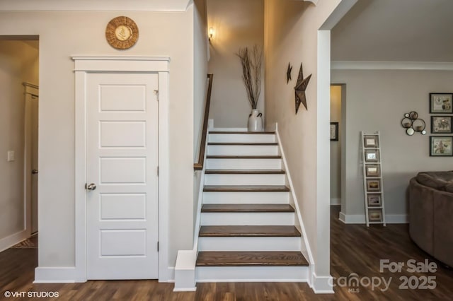 stairway featuring crown molding, baseboards, and wood finished floors