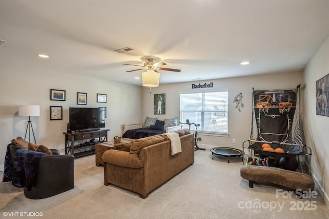 living room featuring ceiling fan, recessed lighting, light carpet, visible vents, and baseboards