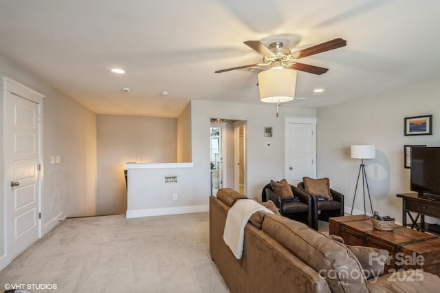 living room featuring recessed lighting, baseboards, ceiling fan, and light colored carpet