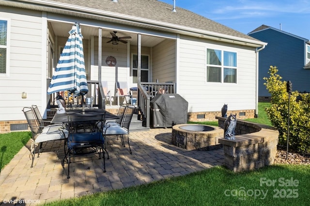 view of patio / terrace with outdoor dining space, an outdoor fire pit, a ceiling fan, and area for grilling