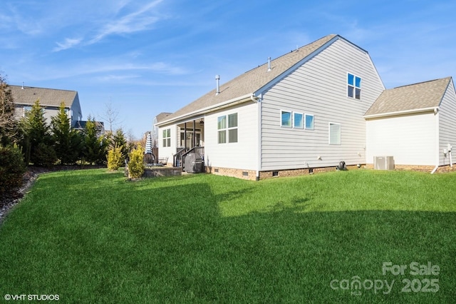 rear view of property featuring crawl space and a lawn