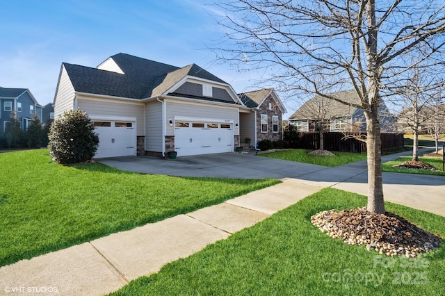 view of front of house featuring a garage, a shingled roof, concrete driveway, stone siding, and a front lawn