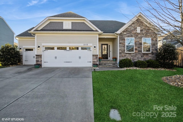 view of front of property featuring driveway, stone siding, an attached garage, and a front yard