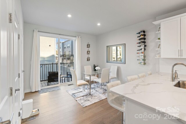 dining space with recessed lighting and wood finished floors