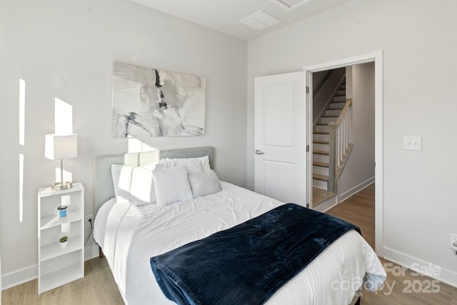 bedroom featuring baseboards and wood finished floors