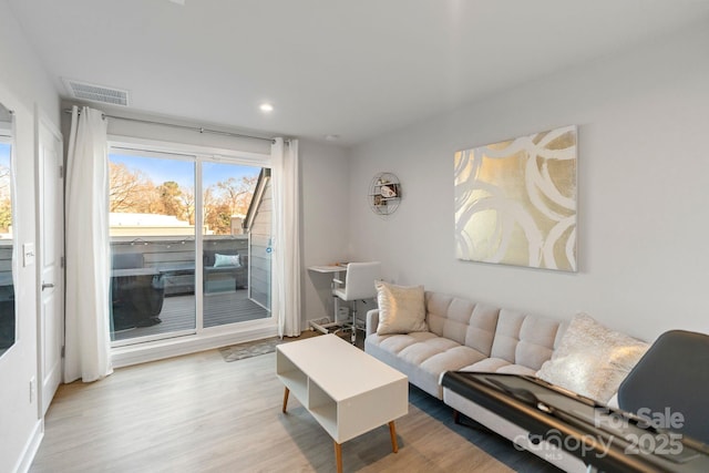 living area featuring visible vents, recessed lighting, and wood finished floors