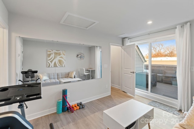 interior space featuring attic access, recessed lighting, wood finished floors, and baseboards