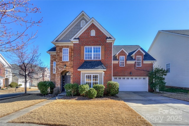 traditional-style home with brick siding, driveway, a front lawn, and a garage