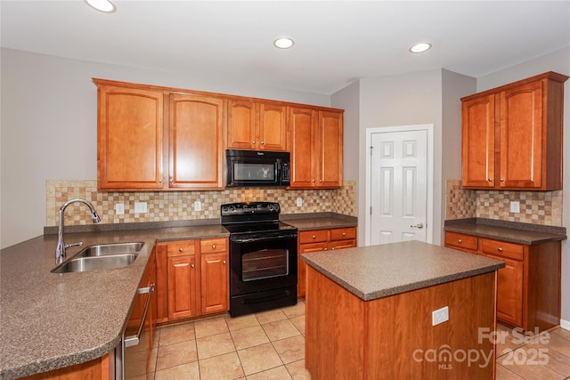 kitchen with black appliances, a sink, dark countertops, a peninsula, and light tile patterned floors