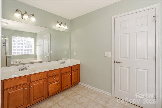 bathroom with double vanity, a bath, visible vents, and a sink