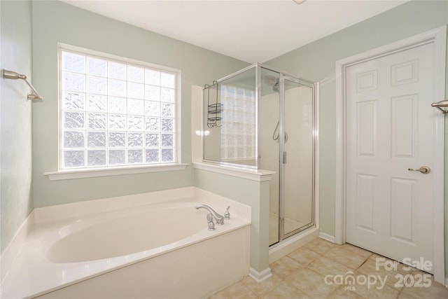 full bath featuring tile patterned floors, a bath, and a shower stall