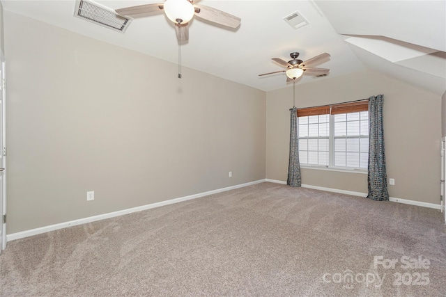 spare room with a ceiling fan, visible vents, carpet floors, and baseboards