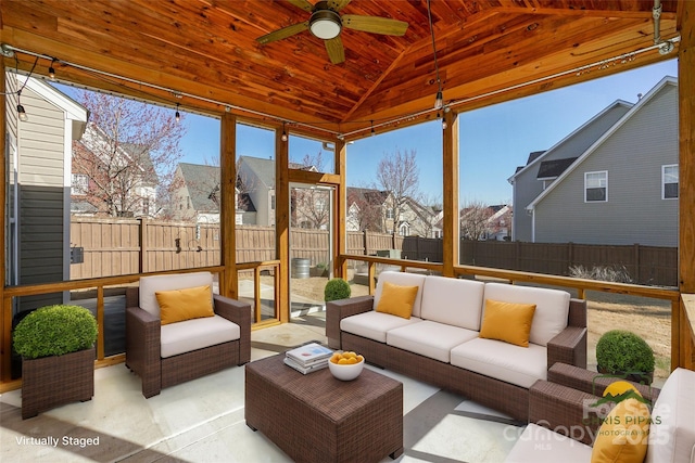 sunroom / solarium featuring a residential view, lofted ceiling, wood ceiling, and a ceiling fan