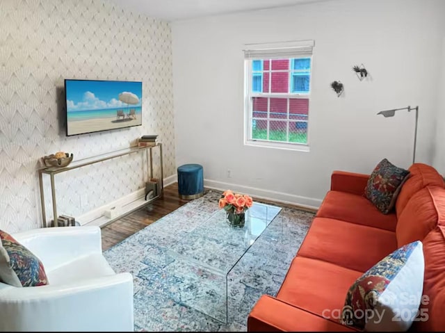 living area with baseboards and wood finished floors