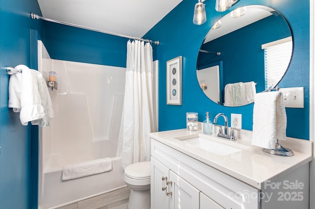 bathroom featuring toilet, shower / bath combo with shower curtain, wood finished floors, and vanity