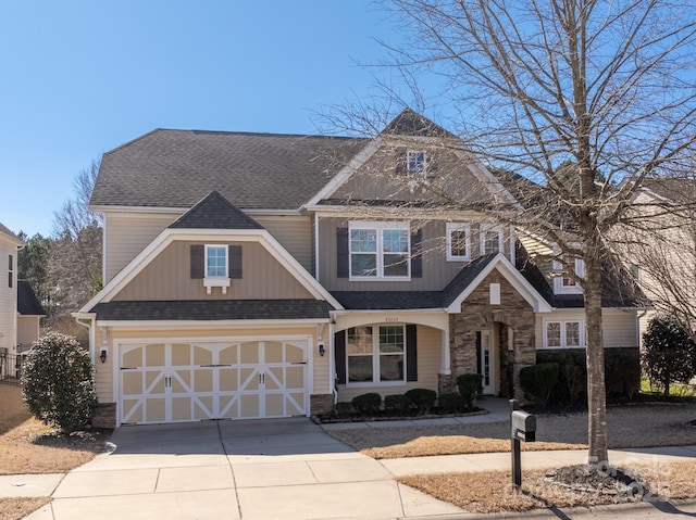 view of front facade featuring driveway, a garage, a shingled roof, stone siding, and board and batten siding