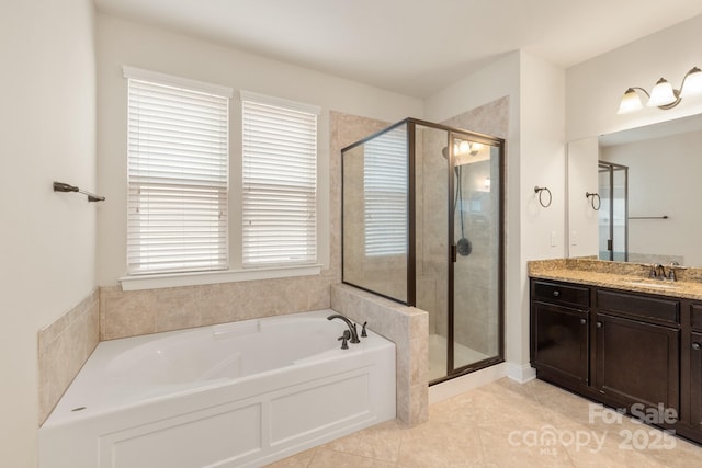 full bath featuring a stall shower, a garden tub, vanity, and tile patterned floors