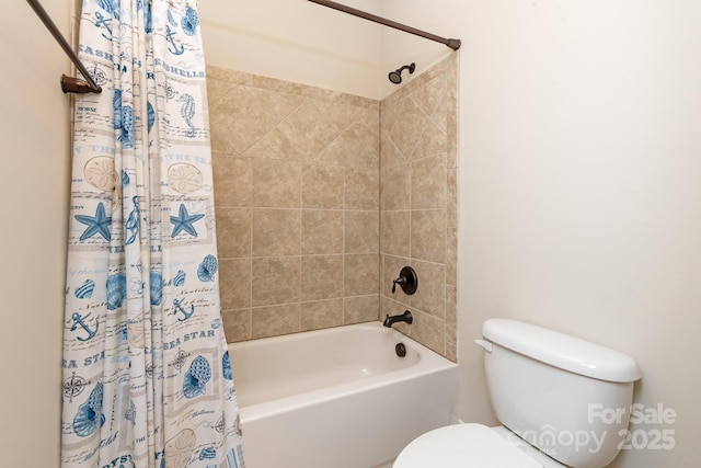 bathroom featuring shower / bath combo and toilet