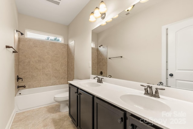 bathroom featuring toilet, shower / bath combination, a sink, tile patterned floors, and double vanity