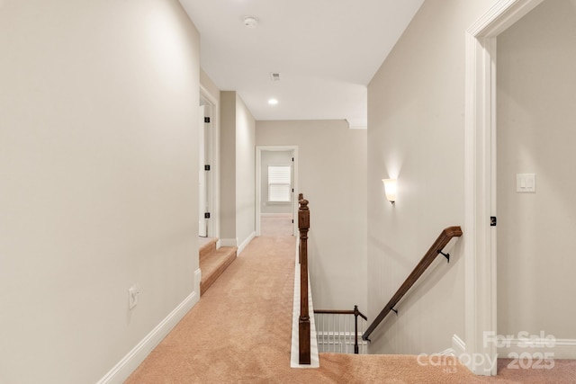 hall featuring recessed lighting, baseboards, light carpet, and an upstairs landing