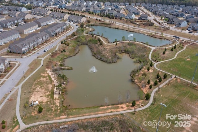 bird's eye view featuring a water view and a residential view