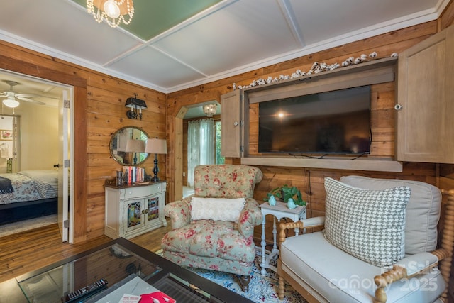 living room with wood walls, ceiling fan, arched walkways, and wood finished floors