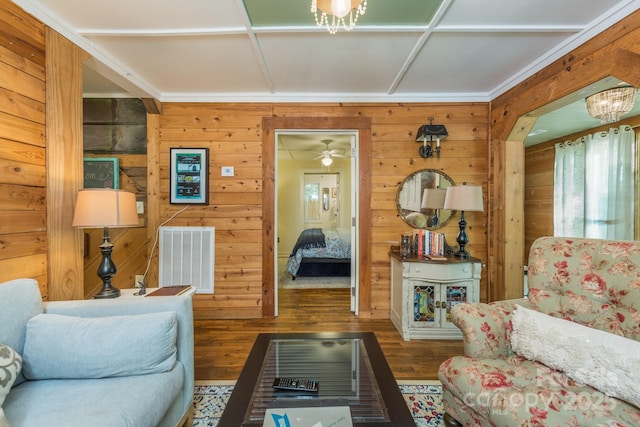 living area featuring visible vents, wooden walls, and wood finished floors