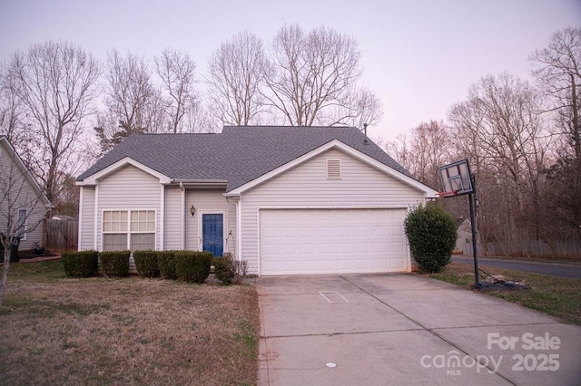 ranch-style house with a garage, driveway, and roof with shingles