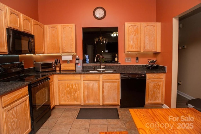 kitchen featuring light brown cabinets, a sink, and black appliances