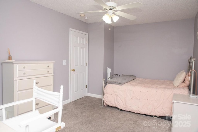 bedroom with light carpet, ceiling fan, a textured ceiling, and baseboards