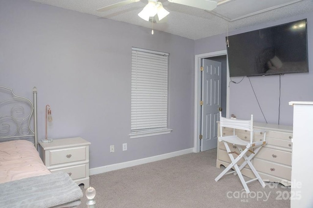 bedroom with attic access, baseboards, ceiling fan, and light colored carpet